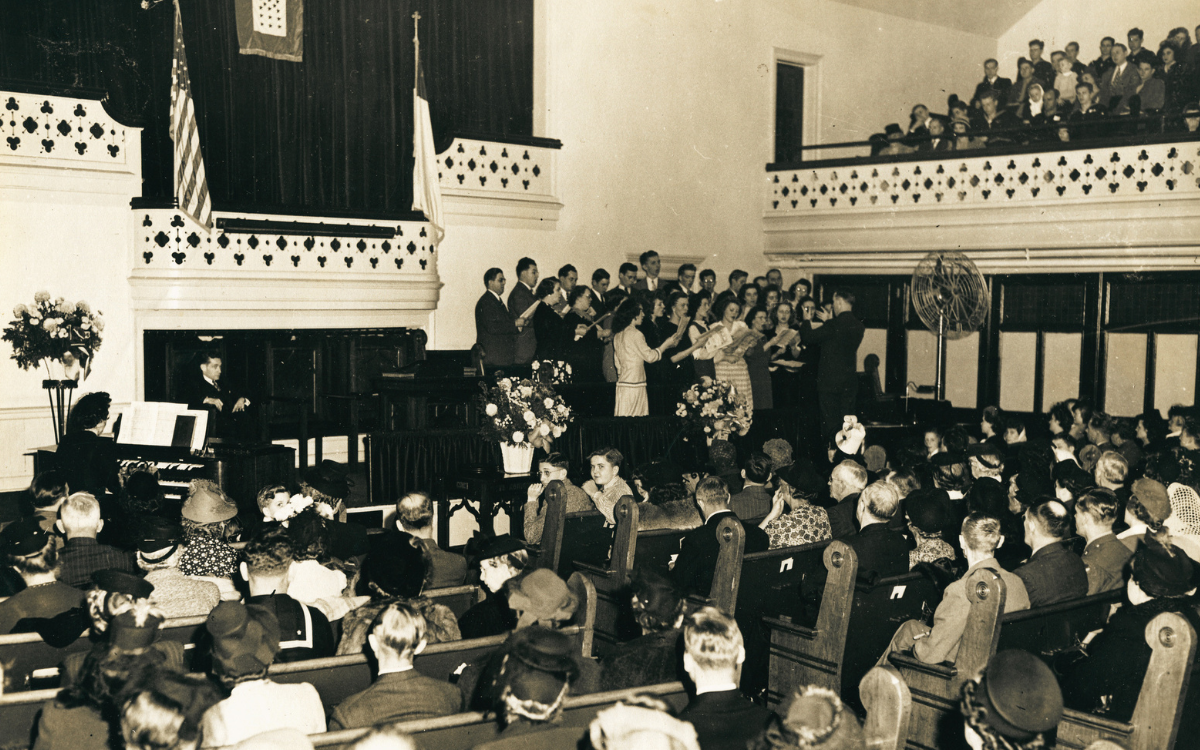 A black and white photo of a crowded church service.